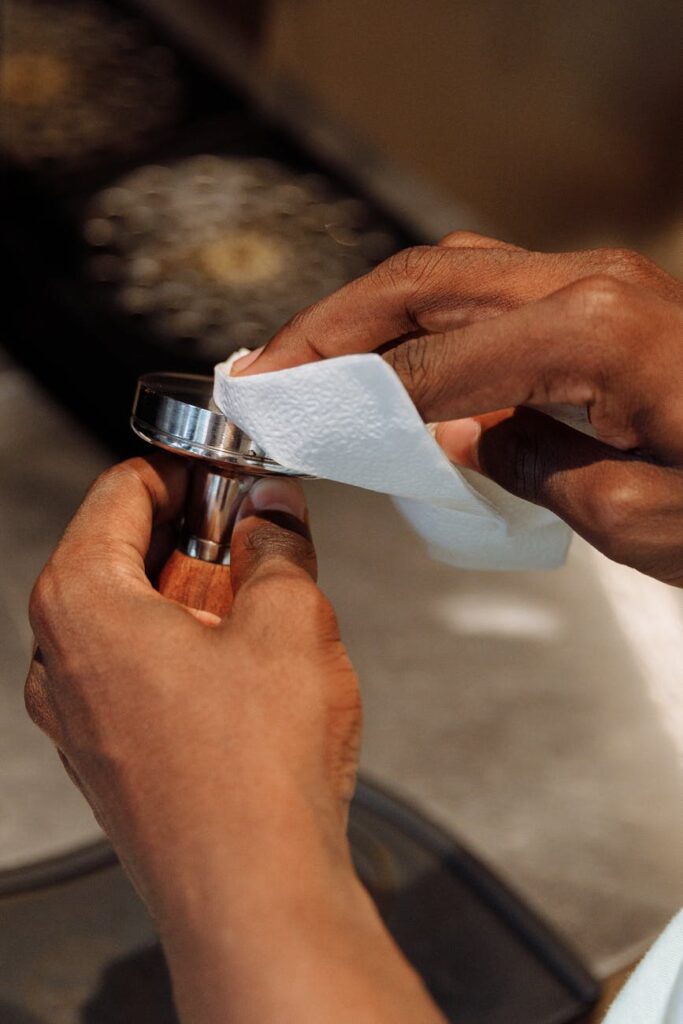 a person cleaning a tamper